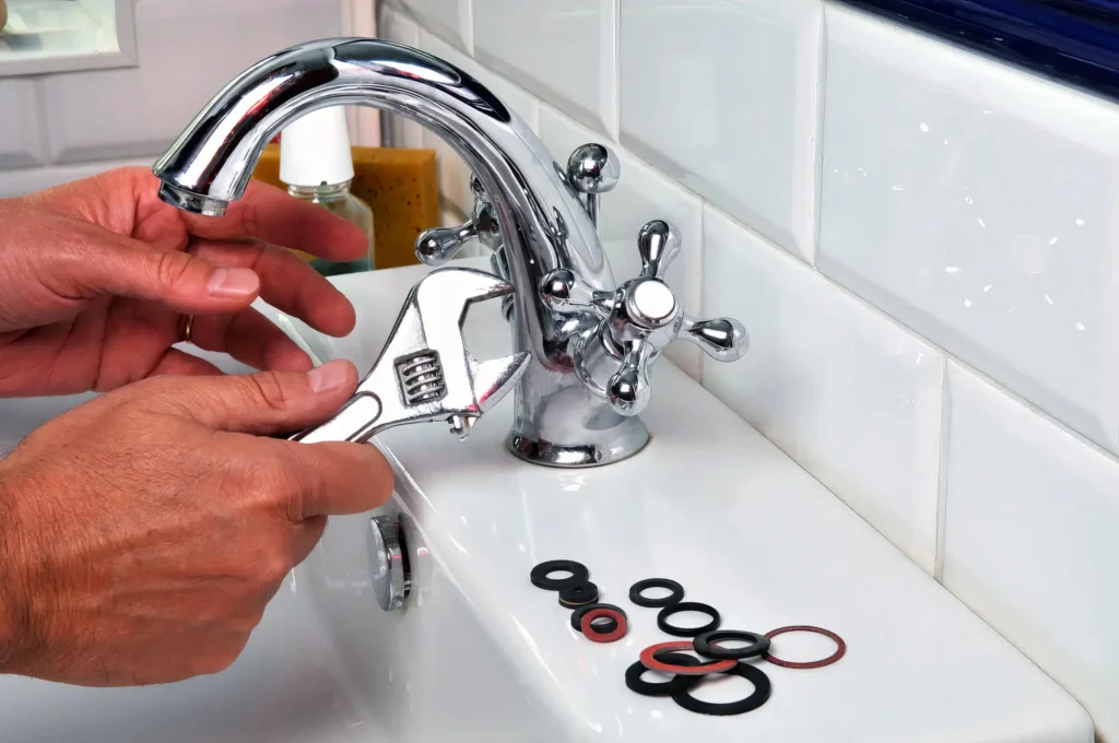 Plumber performing maintenance on a bathroom faucet in Smyrna