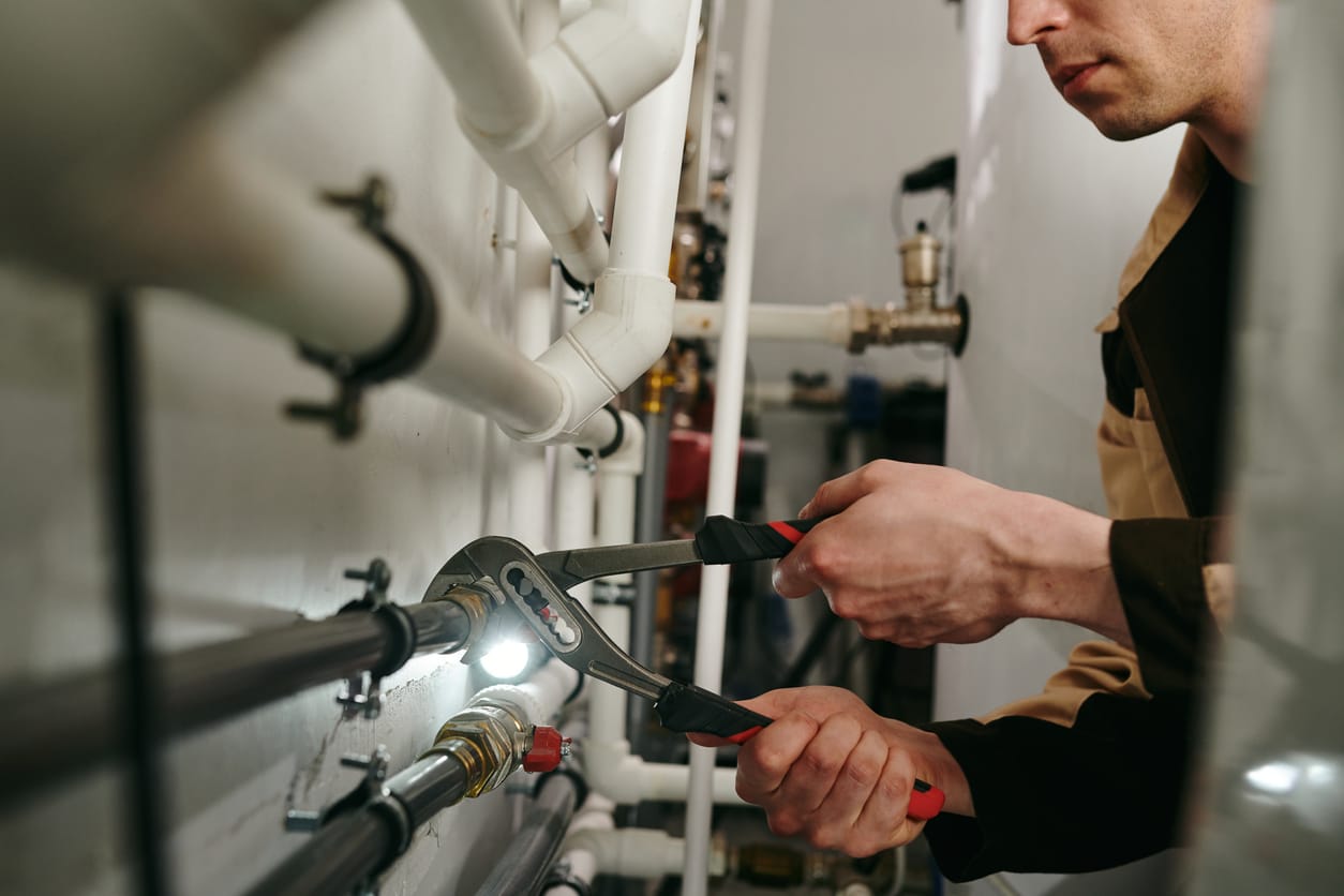 Plumbers maintaining commercial plumbing pipes in Smyrna