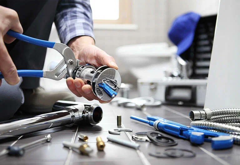 Technician repairing a plumbing fixture with professional tools in Smyrna