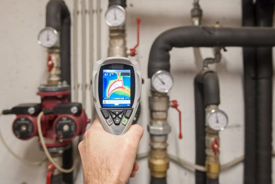 Plumber using a thermal imaging camera to inspect pipes in Smyrna
