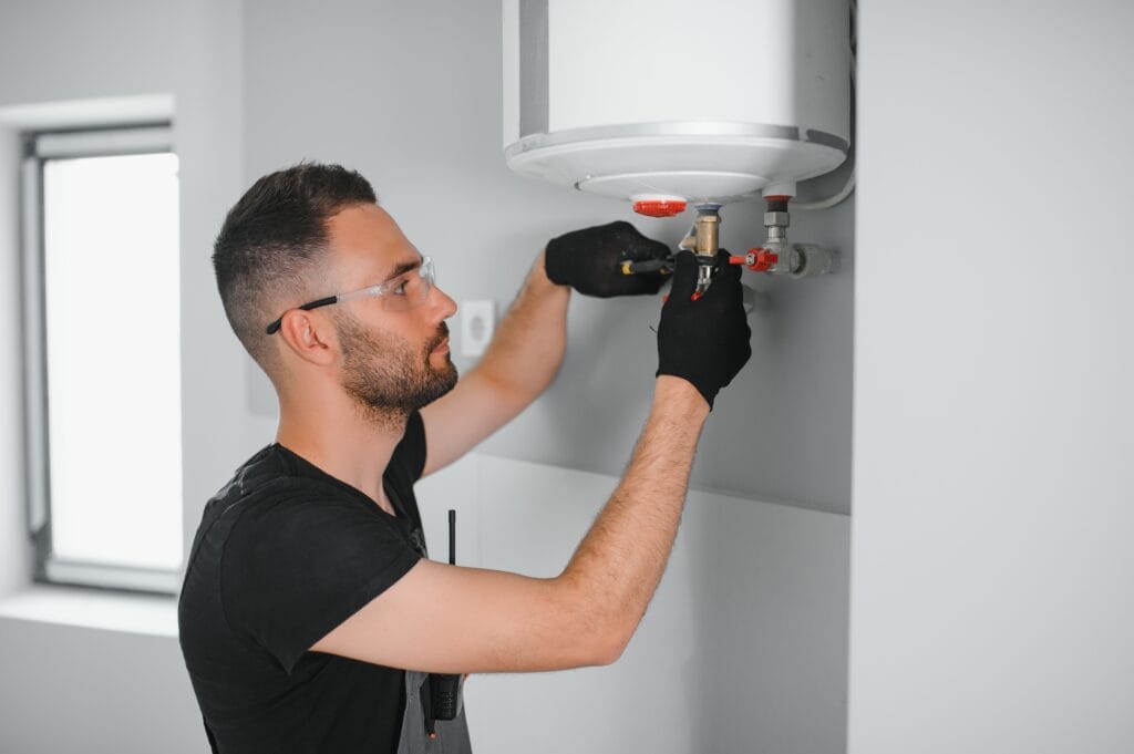 Technician performing water heater maintenance in Smyrna