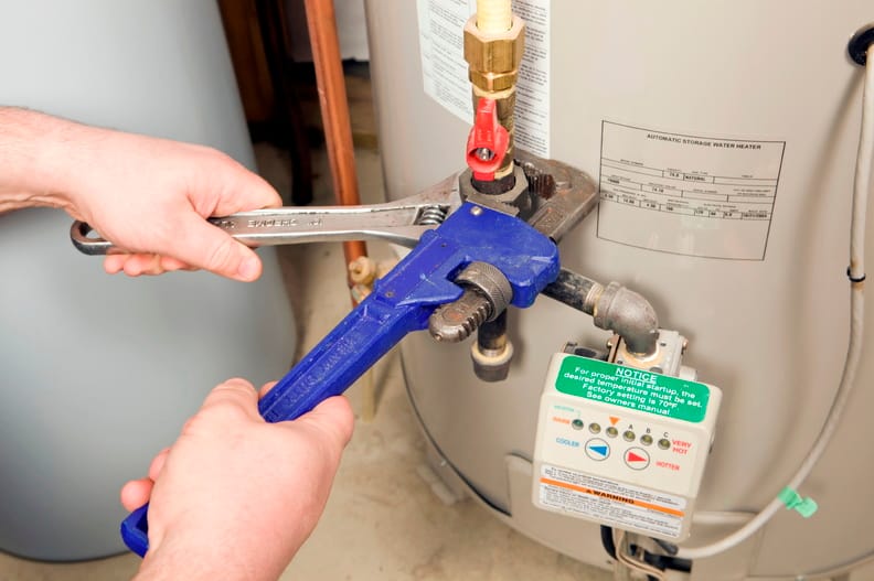 Plumber repairing a water heater valve in Smyrna
